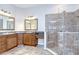 Beautiful bathroom featuring dual sinks, a tiled shower with glass enclosure, and vanity space at 1208 Carriage Park Dr, Valrico, FL 33594