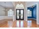 Elegant foyer with hardwood floors, high ceilings, chandelier, and large windows creating a grand entrance at 1208 Carriage Park Dr, Valrico, FL 33594