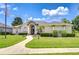 Well-manicured front yard with a lush green lawn and elegant landscaping creating a welcoming entrance at 1208 Carriage Park Dr, Valrico, FL 33594