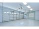 Spacious two-car garage with good ceiling height and lighting at 1208 Carriage Park Dr, Valrico, FL 33594
