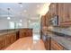 Large kitchen with wood cabinets, stainless appliances, and granite countertops at 1208 Carriage Park Dr, Valrico, FL 33594