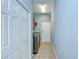 Functional laundry room with a washer and dryer, tile flooring, and closet at 1208 Carriage Park Dr, Valrico, FL 33594