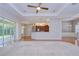 Spacious living room features hardwood floors and an open floor plan to the kitchen at 1208 Carriage Park Dr, Valrico, FL 33594