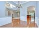 Open-concept living space featuring hardwood floors, fireplace, and seamless flow to the kitchen area at 1208 Carriage Park Dr, Valrico, FL 33594