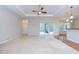 Spacious main bedroom with tray ceiling, ceiling fan, and sliding door access to the outdoors at 1208 Carriage Park Dr, Valrico, FL 33594