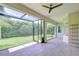 This covered lanai provides a peaceful outdoor space, with views of the lush, green backyard at 1208 Carriage Park Dr, Valrico, FL 33594