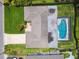 Aerial view of a home with a screened-in pool and well-manicured lawn at 1270 Inverness, Dunedin, FL 34698