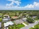 Aerial view of a residential neighborhood with lush landscaping on a sunny day at 1270 Inverness, Dunedin, FL 34698