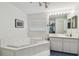 This bathroom offers a large soaking tub with tiled trim, a full mirror and plenty of vanity space at 1270 Inverness, Dunedin, FL 34698