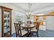 Dining area featuring a chandelier and glass cabinet next to kitchen at 1270 Inverness, Dunedin, FL 34698