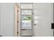The entrance foyer features a glass paned door and white painted walls at 1270 Inverness, Dunedin, FL 34698
