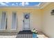 Front entrance of the home with a decorative wreath and vibrant flowers at 1270 Inverness, Dunedin, FL 34698