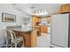 Kitchen with light wood cabinetry, granite countertops, and a breakfast bar at 1270 Inverness, Dunedin, FL 34698