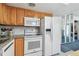 Kitchen features white appliances, light wood cabinets, and lots of counter space at 1270 Inverness, Dunedin, FL 34698