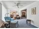Bright living room with neutral walls and carpet, ceiling fan, and view to kitchen and dining at 1270 Inverness, Dunedin, FL 34698