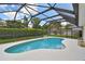 Screened-in pool with clear blue water, surrounded by a well-maintained deck and landscaping at 1270 Inverness, Dunedin, FL 34698