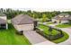 Stunning aerial view of home showcasing meticulously maintained landscaping, driveway, and exterior lighting at 12862 Rangeland Blvd, Odessa, FL 33556