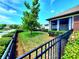 Beautiful backyard showcasing a well-kept lawn, manicured shrubs, and a screened lanai, all within a fenced perimeter at 12862 Rangeland Blvd, Odessa, FL 33556