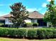 Well-manicured backyard showcasing a fenced perimeter, lush landscaping, and a view of the home's exterior at 12862 Rangeland Blvd, Odessa, FL 33556