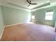 Bedroom with carpet flooring, crown molding, and natural light from windows at 12862 Rangeland Blvd, Odessa, FL 33556