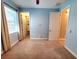 The carpeted bedroom has a walk-in closet and an ensuite bathroom through separate doorways at 12862 Rangeland Blvd, Odessa, FL 33556