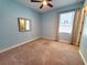 Cozy bedroom with neutral-toned walls, carpet flooring, and a window dressed with elegant curtains at 12862 Rangeland Blvd, Odessa, FL 33556