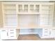 Close-up of built-in shelves and cabinets in living room, featuring desk space and storage at 12862 Rangeland Blvd, Odessa, FL 33556