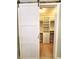 Walk-in closet with white shelving and storage accessed through a barn door at 12862 Rangeland Blvd, Odessa, FL 33556