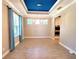 Bright dining room featuring a coffered ceiling, modern light fixture, and adjacent access to the kitchen at 12862 Rangeland Blvd, Odessa, FL 33556