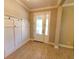 Bright entryway with coat rack, tiled floor, and neutral color palette at 12862 Rangeland Blvd, Odessa, FL 33556