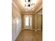 Bright entryway with coat rack, tiled floor, and modern light fixture at 12862 Rangeland Blvd, Odessa, FL 33556