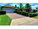 Well-maintained home with an inviting brick driveway framed by manicured hedges and a tidy lawn at 12862 Rangeland Blvd, Odessa, FL 33556