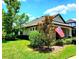 Charming single-story home with American flag, well-kept landscaping, and beautiful green lawn at 12862 Rangeland Blvd, Odessa, FL 33556