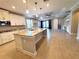 Open-concept kitchen with granite countertops, large island, stainless appliances, and adjacent living space at 12862 Rangeland Blvd, Odessa, FL 33556
