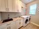 Laundry room with modern appliances, ample counter space, and stylish cabinetry at 12862 Rangeland Blvd, Odessa, FL 33556