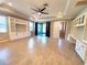 Bright living room with built-in shelving, coffered ceilings, and sliding door access to the outdoor space at 12862 Rangeland Blvd, Odessa, FL 33556