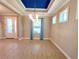 Open-concept living room with tiled floor, bright windows, and modern lighting at 12862 Rangeland Blvd, Odessa, FL 33556