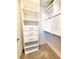 This organized walk-in closet features custom shelving, drawers, and hanging space for efficient storage at 12862 Rangeland Blvd, Odessa, FL 33556