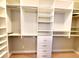 Bright walk-in closet features custom shelving and drawers for ample storage, keeping your wardrobe organized at 12862 Rangeland Blvd, Odessa, FL 33556