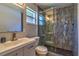 Bathroom with a marble shower, vanity, and mirror at 13029 111Th Ln, Largo, FL 33778