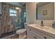 Bathroom with marble shower, white vanity and sink, and decorative mirror at 13029 111Th Ln, Largo, FL 33778