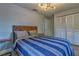 Neutral bedroom with wood flooring, a wood bed frame, and a double closet at 13029 111Th Ln, Largo, FL 33778