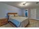 Bedroom featuring wood flooring, a bed frame, and an open bathroom at 13029 111Th Ln, Largo, FL 33778
