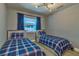 Bedroom with 2 twin beds and blue accents at 13029 111Th Ln, Largo, FL 33778