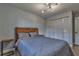 Neutral bedroom featuring wood flooring, a wood bed frame, and a closet at 13029 111Th Ln, Largo, FL 33778