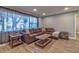 Bright living room with a large window, wood-look flooring, and a cozy sectional sofa at 13029 111Th Ln, Largo, FL 33778