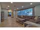 Bright living room with a large window, wood-look flooring, and a cozy sectional sofa at 13029 111Th Ln, Largo, FL 33778