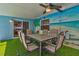 Outdoor dining area with table, chairs and mural on the wall at 13029 111Th Ln, Largo, FL 33778