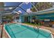 Beautiful backyard featuring a screened-in pool, an outdoor bar area and lush landscaping at 13029 111Th Ln, Largo, FL 33778