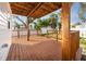 Large back deck with wooden railings and a covered area with lighting is great for entertaining guests at 13148 3Rd E St, Madeira Beach, FL 33708